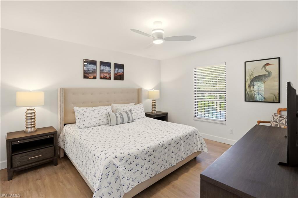 600 Neapolitan Way, Unit 254 Naples, FL 34103 - Photo 17 of 42 Bedroom with light wood-type flooring and ceiling fan