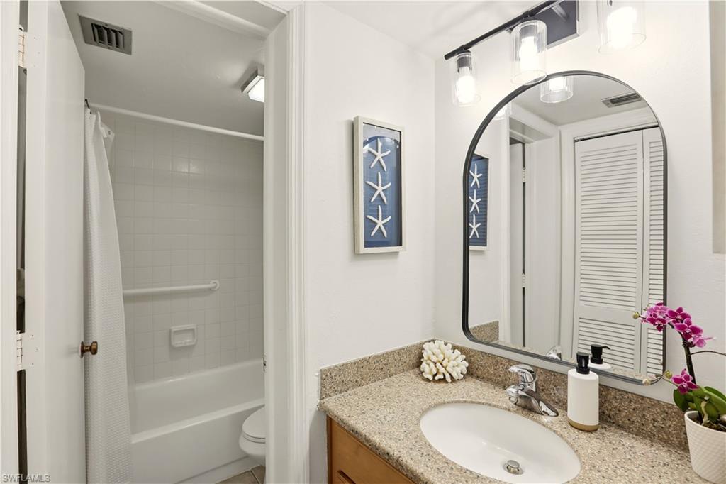 600 Neapolitan Way, Unit 254 Naples, FL 34103 - Photo 21 of 42 Bathroom featuring vanity and shower / tub combo