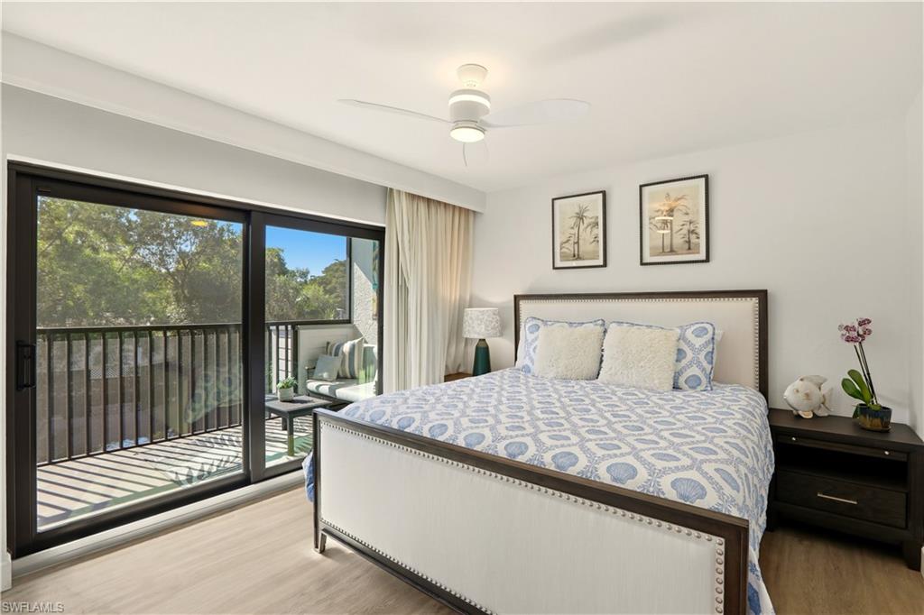 600 Neapolitan Way, Unit 254 Naples, FL 34103 - Photo 22 of 42 Bedroom featuring light wood-style floors, access to exterior, and a ceiling fan