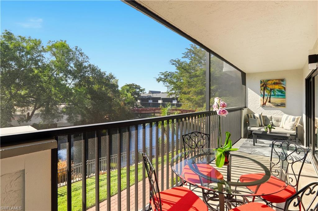 600 Neapolitan Way, Unit 254 Naples, FL 34103 - Photo 30 of 42 Balcony with a sunroom