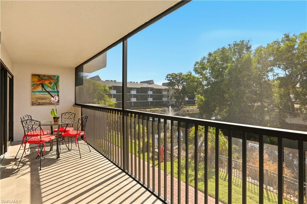 600 Neapolitan Way, Unit 254 Naples, FL 34103 - Photo 31 of 42 Balcony featuring a sunroom