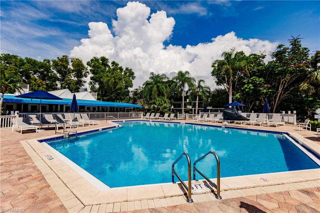 600 Neapolitan Way, Unit 254 Naples, FL 34103 - Photo 4 of 42 Community pool with a patio