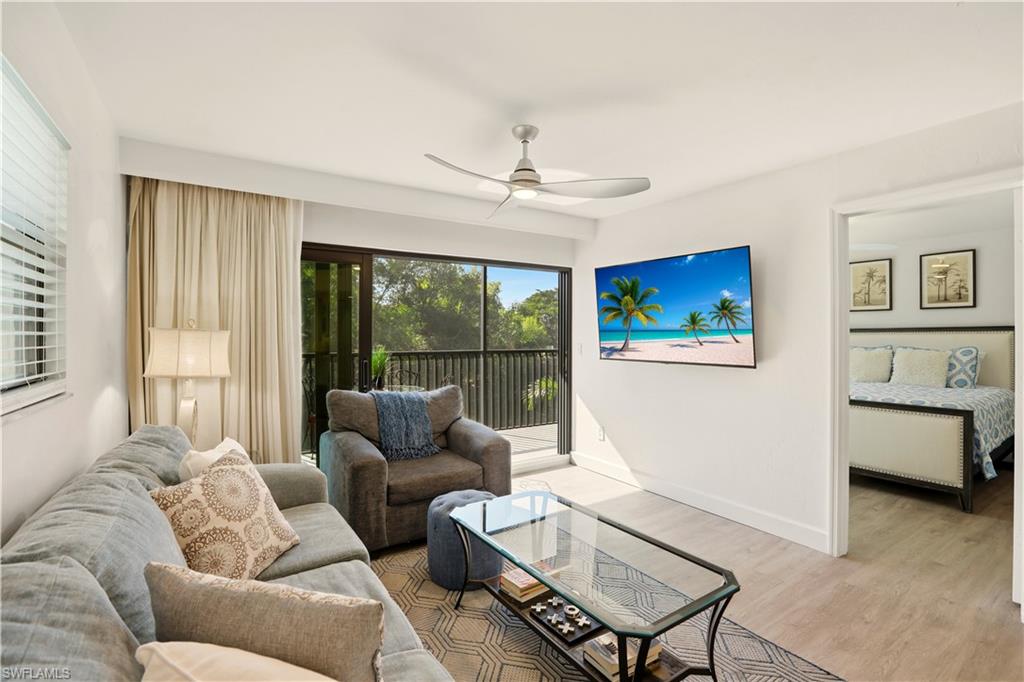 600 Neapolitan Way, Unit 254 Naples, FL 34103 - Photo 5 of 42 Living area with ceiling fan and light wood-type flooring