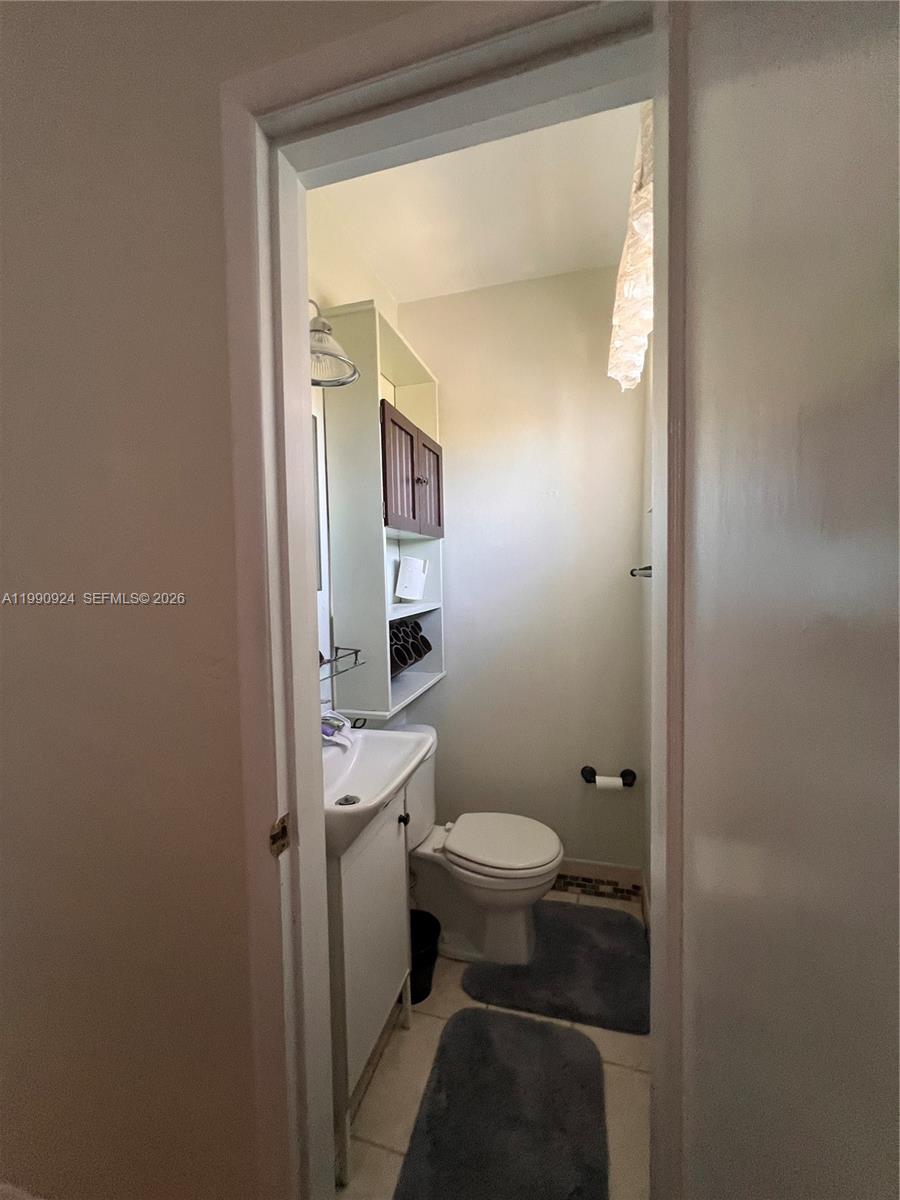 151 West 63rd Street Hialeah, FL 33012 - Photo 8 of 13 a bathroom with a sink and a toilet