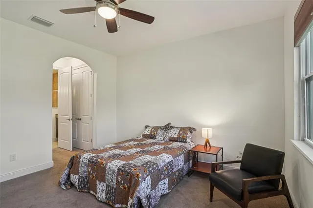 a bedroom with a bed and window