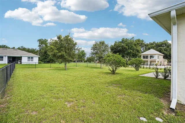a front view of house with yard and trees