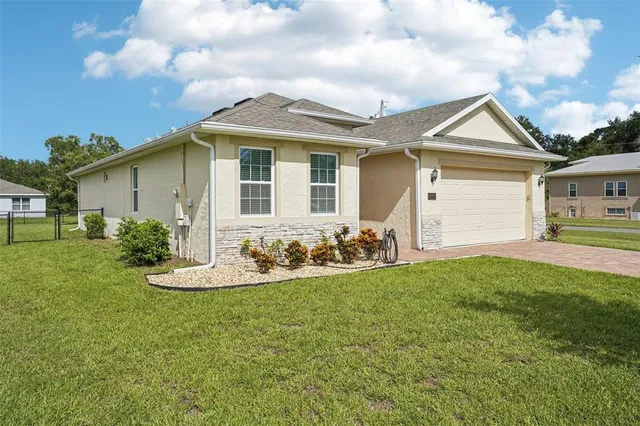 a front view of house with yard and green space