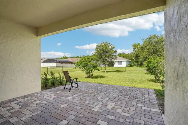 a view of a yard and a trees in the background