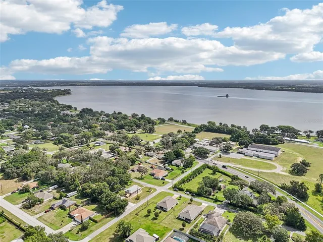 an aerial view of residential building and lake