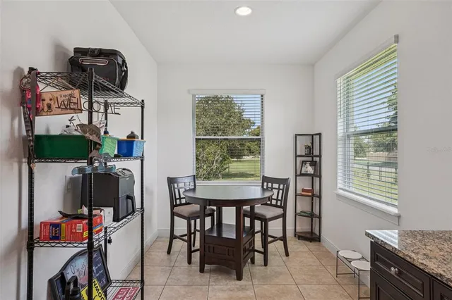 a view of a dining room with furniture and a window