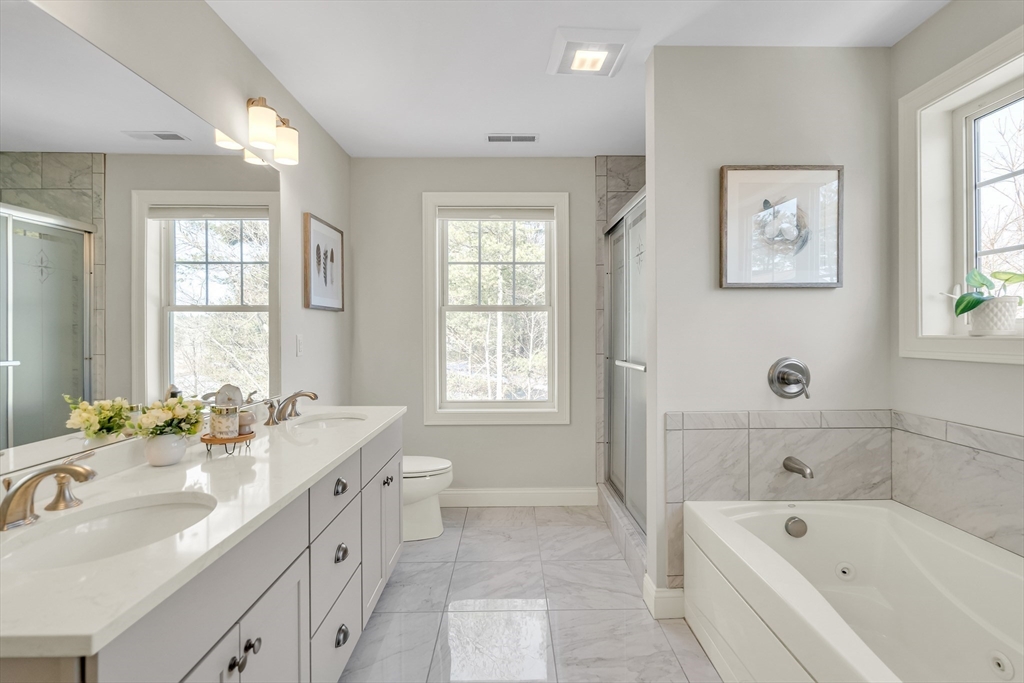 49 Quarry Road, Unit 49 Acton, MA 01720 - Photo 17 of 42 a bathroom with a tub double sink window and mirror