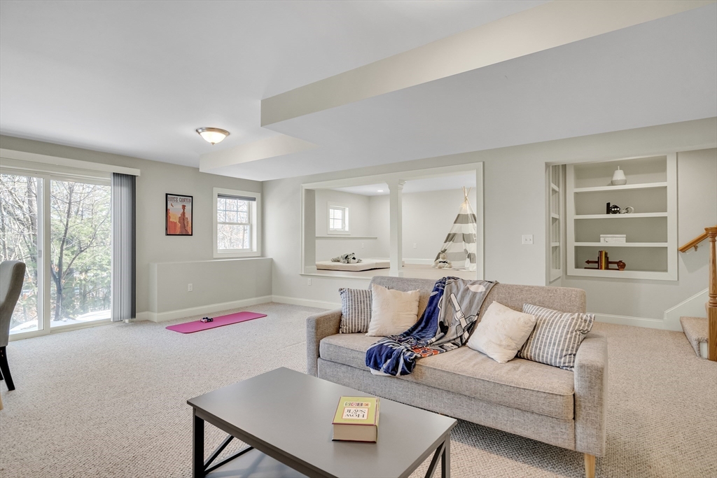 49 Quarry Road, Unit 49 Acton, MA 01720 - Photo 23 of 42 a bedroom with furniture and a wooden floor