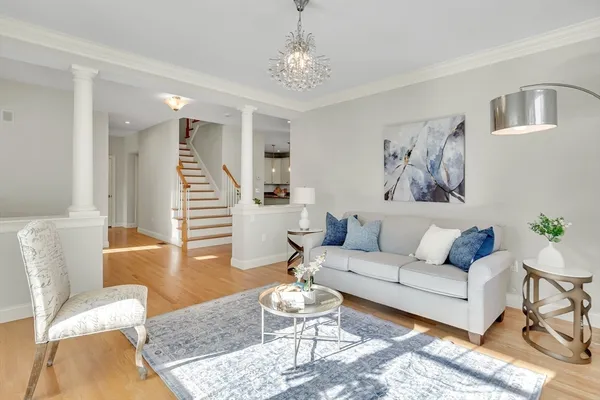 a living room with furniture and a chandelier
