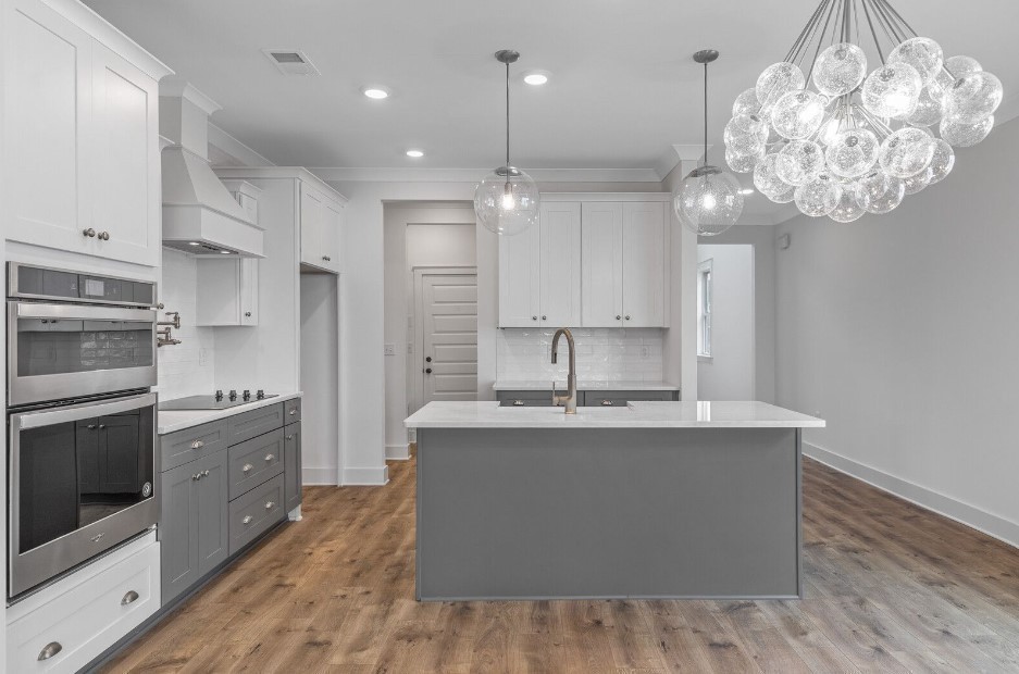 826 Sugarbush Ln Spring Hill Spring Hill, TN 37174 - Photo 6 of 18 a kitchen with kitchen island granite countertop a white cabinets and stainless steel appliances