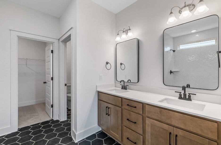 826 Sugarbush Ln Spring Hill Spring Hill, TN 37174 - Photo 10 of 18 a bathroom with double vanity sinks and a mirror