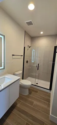 a bathroom with a sink a toilet and a shower