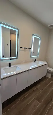 a bathroom with a double vanity sink and mirror