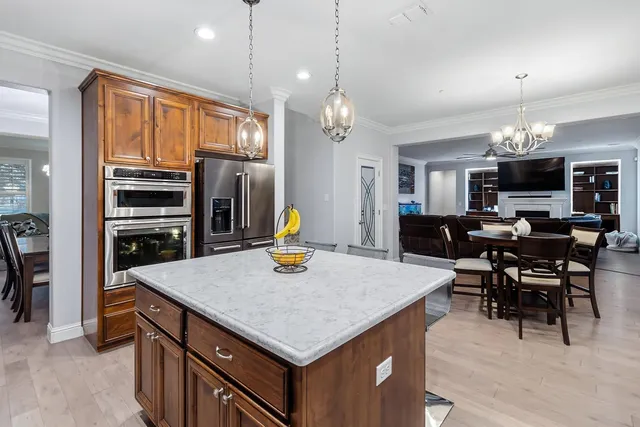 a view of kitchen with sink microwave and dining table