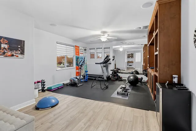 a room with gym equipment and a view of living room