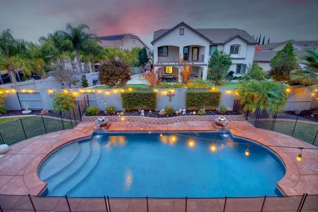 a view of swimming pool with outdoor seating and yard