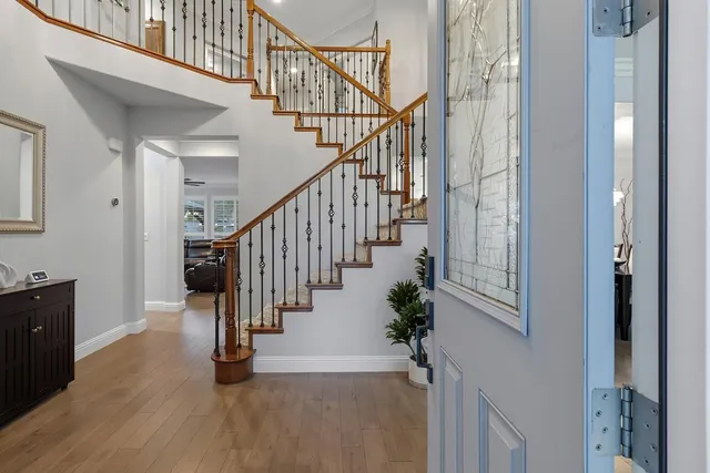 a view of entryway with wooden floor and stairs