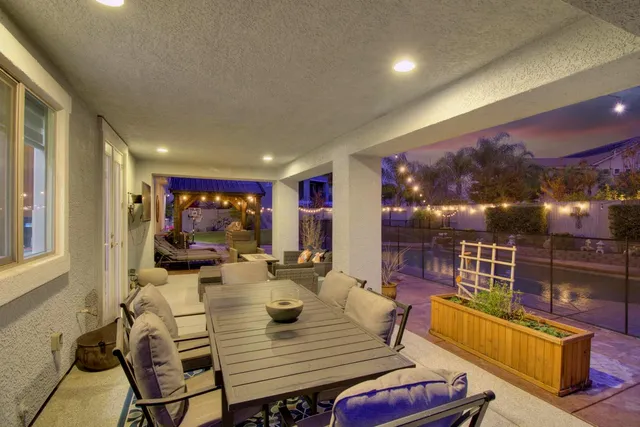 a outdoor living space with furniture potted plant and a large window