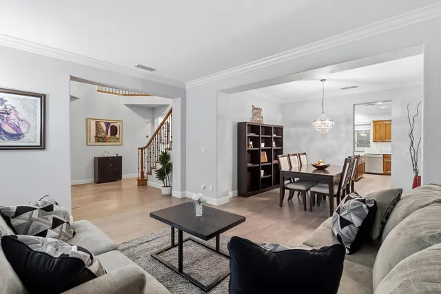 a living room with furniture a table and a large window