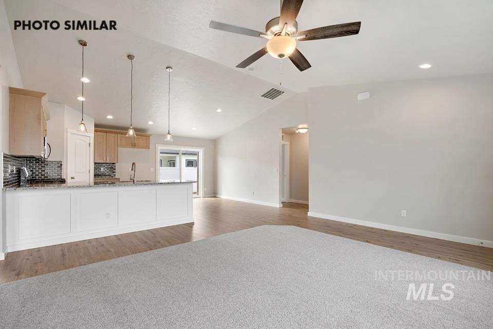 1676 Haystack Road Emmett, ID 83617 - Photo 5 of 32 Open-concept living space featuring vaulted ceilings, wood-finish flooring, and recessed lighting