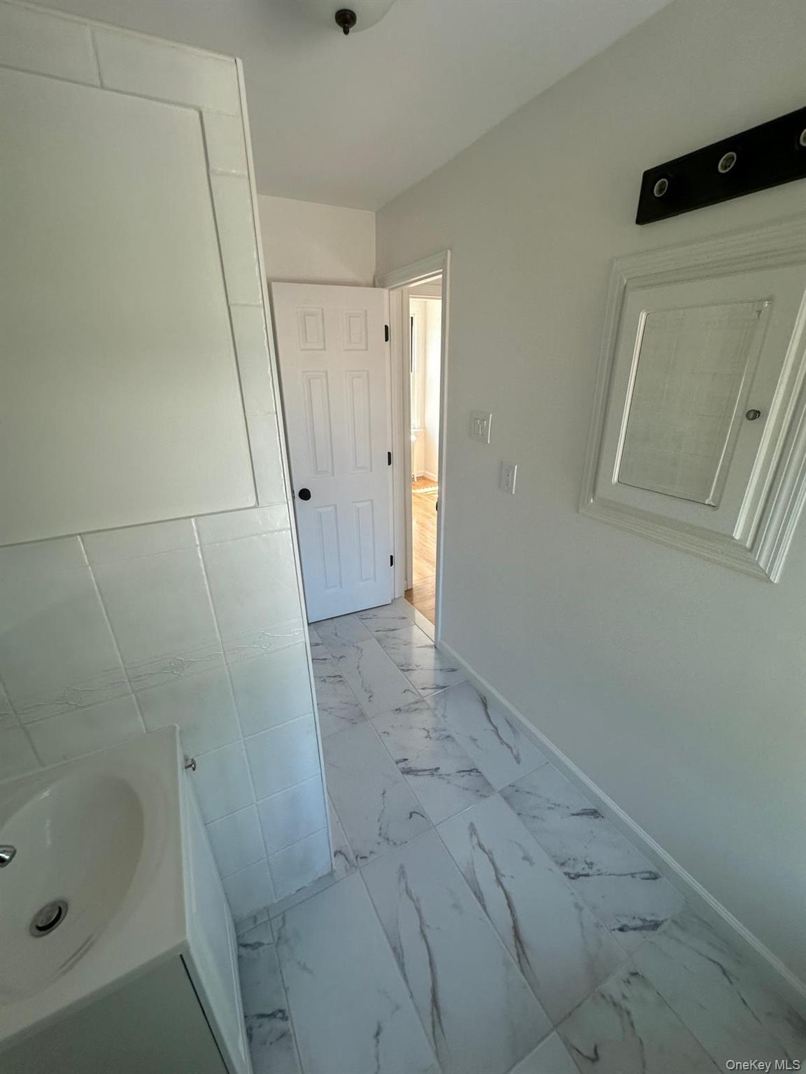 218-17 109th Avenue Queens, NY 11429 - Photo 16 of 35 Bathroom featuring light marble finish floors and vanity