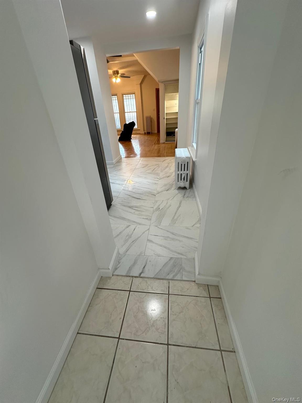 218-17 109th Avenue Queens, NY 11429 - Photo 28 of 35 Corridor with light marble finish floors and radiator