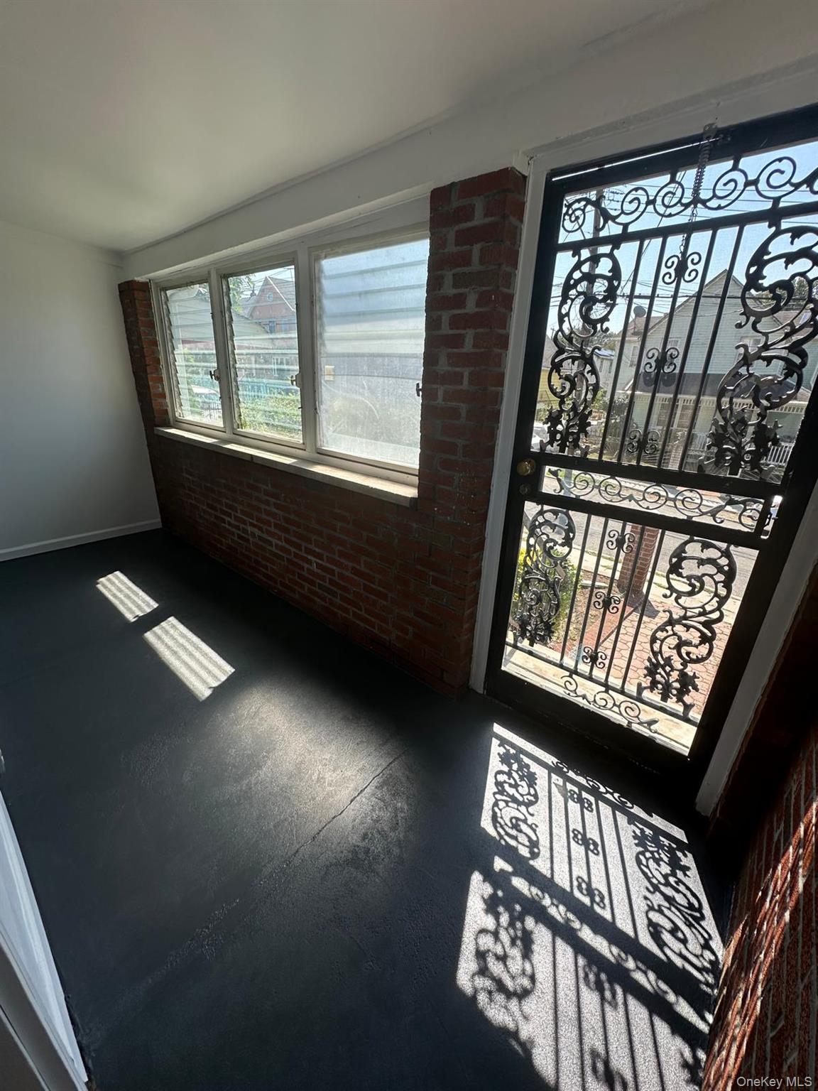 218-17 109th Avenue Queens, NY 11429 - Photo 4 of 35 Foyer featuring brick wall and finished concrete flooring