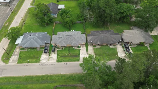 an aerial view of a house with garden space and street view