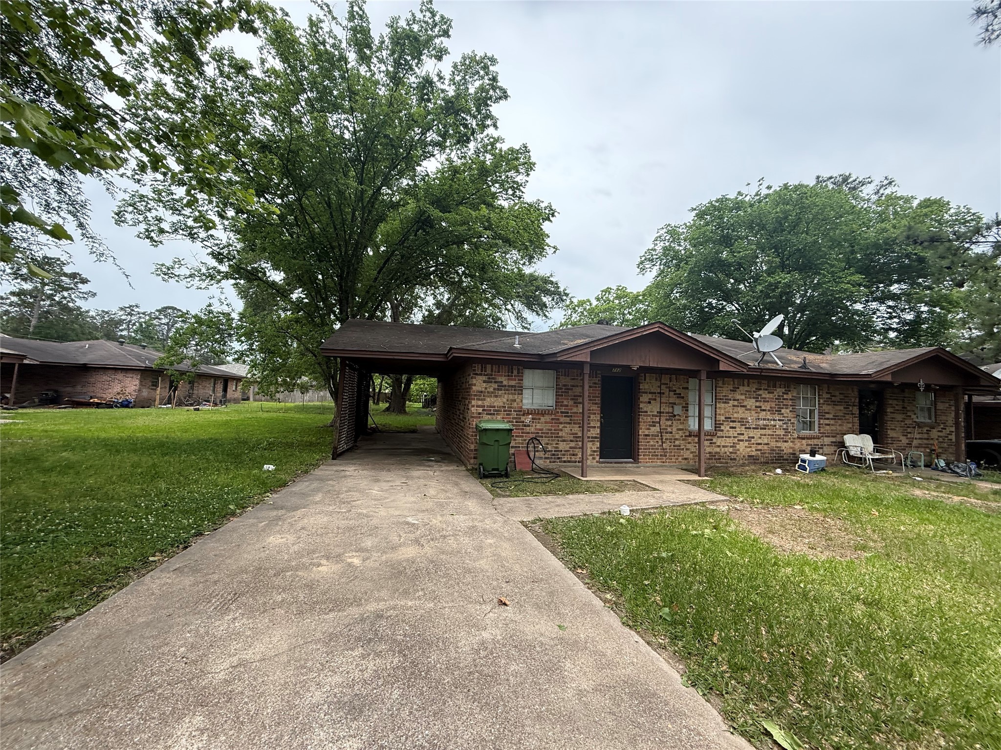 706 Lyle W Avenue, Unit 708 Cleveland, TX 77327 - Photo 6 of 8 a front view of a house with a yard and trees