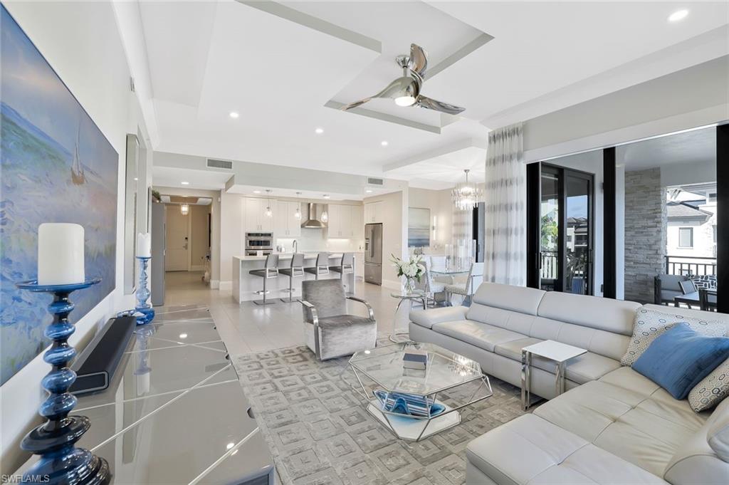 a living room with furniture and a large mirror