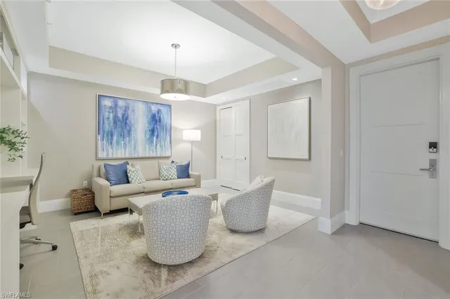 a living room with furniture and a chandelier