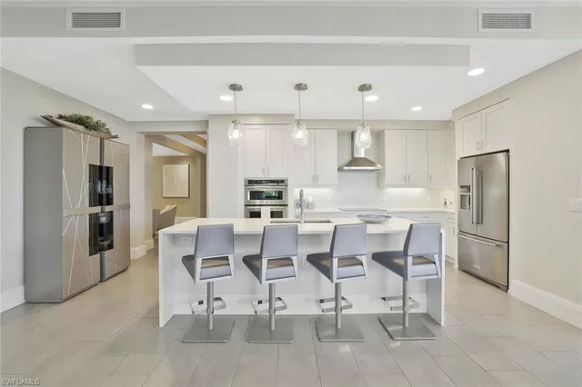 a large kitchen with a table and chairs