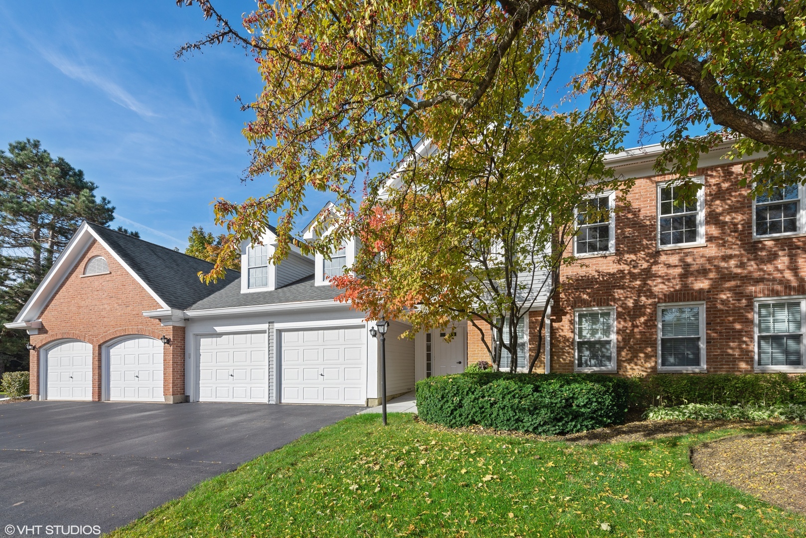 908 Persimmon Lane, Unit D Mount Prospect, IL 60056 - Photo 1 of 1 a front view of a house with a yard and garage