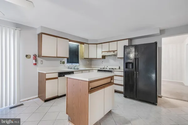 a kitchen with stainless steel appliances granite countertop a stove a refrigerator and a sink