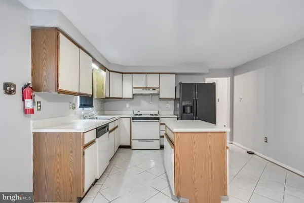 a kitchen with a sink stove and refrigerator