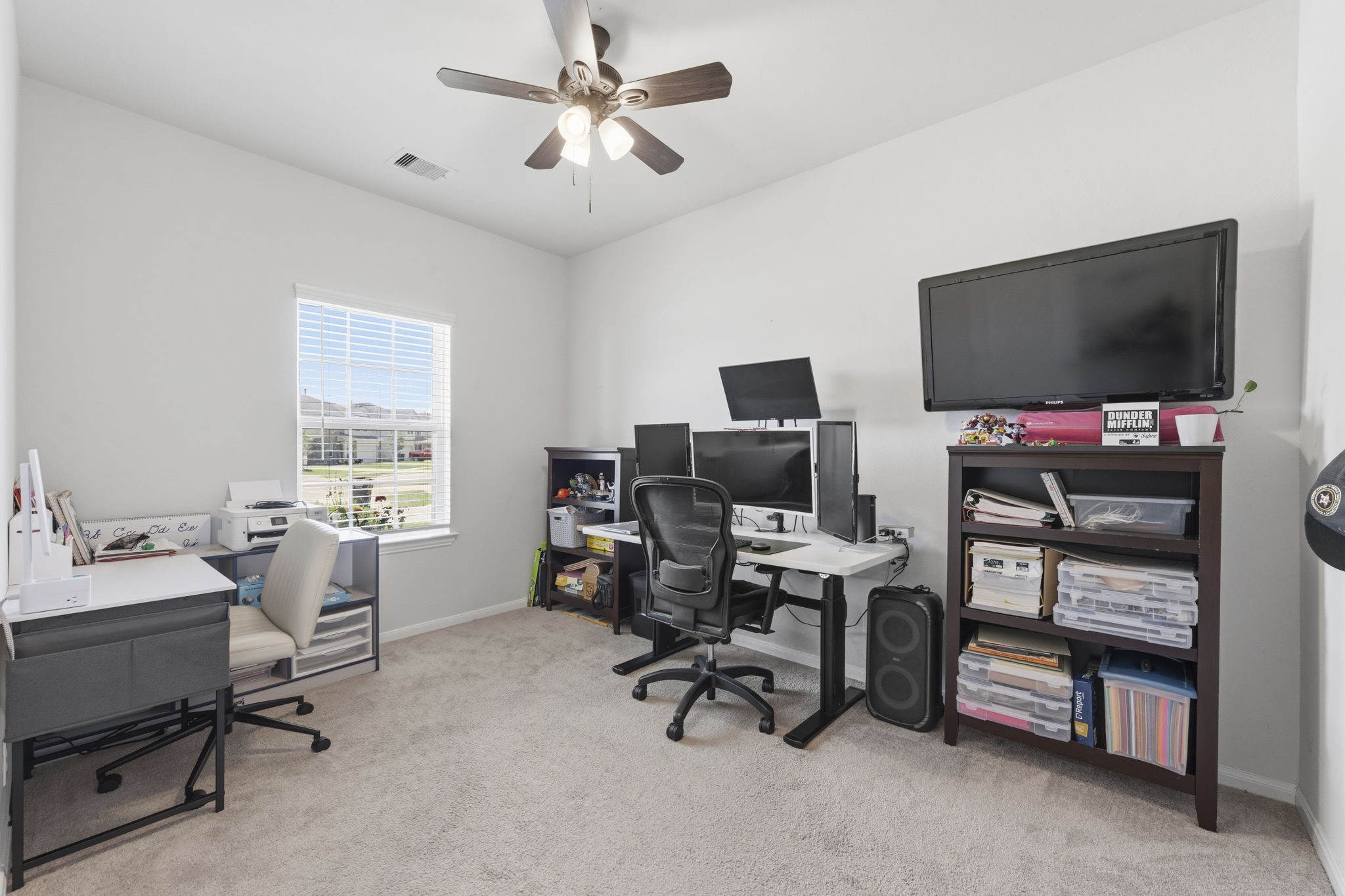 2401 Abbot Brk Drive Rosharon, TX 77583 - Photo 7 of 50 Enjoy working from home in this bright and inviting private office, thoughtfully designed to balance comfort, style, and productivity. A large window adorned with blinds fills the space with natural light, while plush carpeting and a lighted ceiling fan create a warm and comfortable atmosphere. Equipped with all the necessary connections for today’s remote lifestyle, this space is perfectly suited for a seamless work-from-home experience.