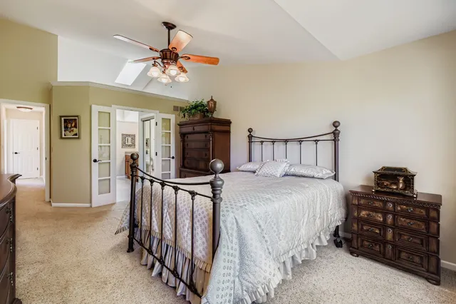 a bedroom with a bed and a chandelier