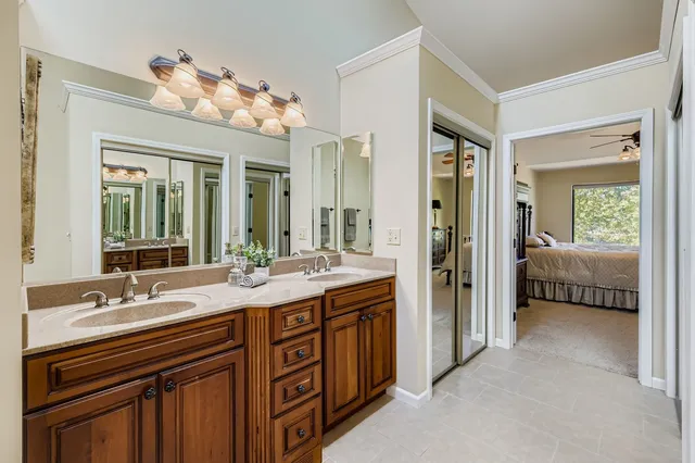 a en suite bathroom with a sink double vanity and a mirror