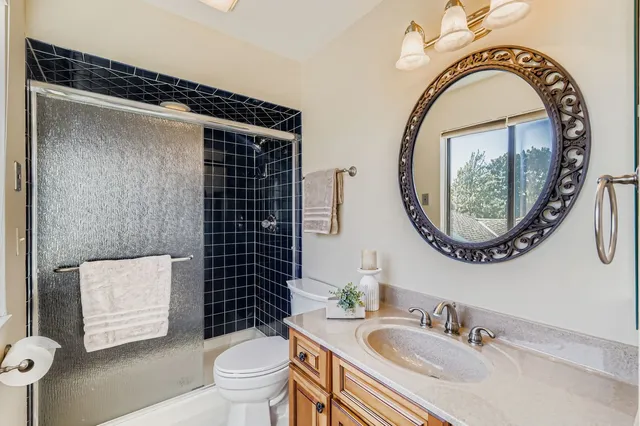 a bathroom with a sink a toilet and a mirror