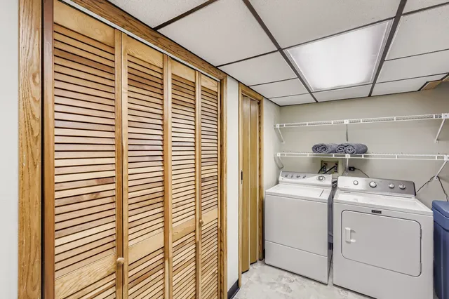 a view of storage and utility room with washer and dryer