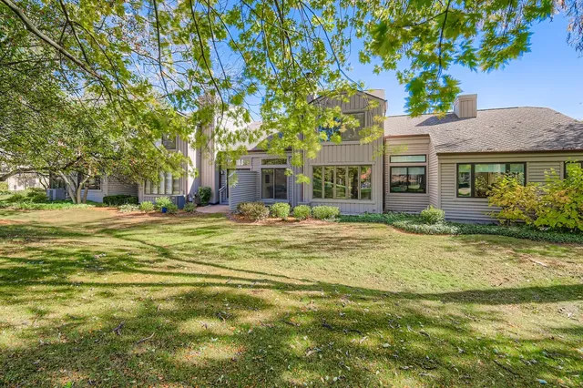 a swimming pool with trees in front of it