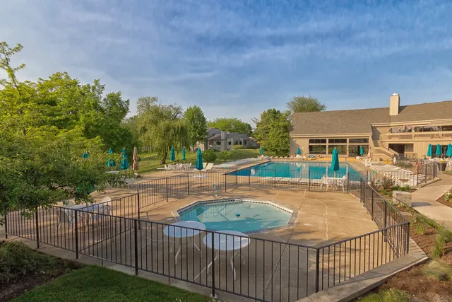 a view of a swimming pool and a patio