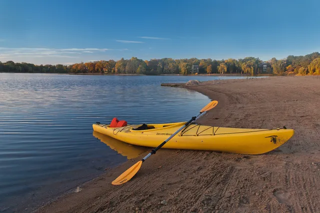 a living room with furniture and a dining table with wooden floors