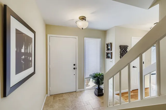 a view of entryway with paintings on the walls