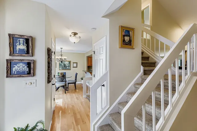 a view of a livingroom with furniture staircase and windows