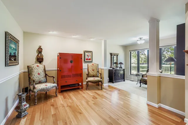 a bedroom with furniture and a large window